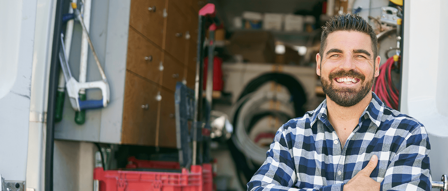 Person smiling in front of van.